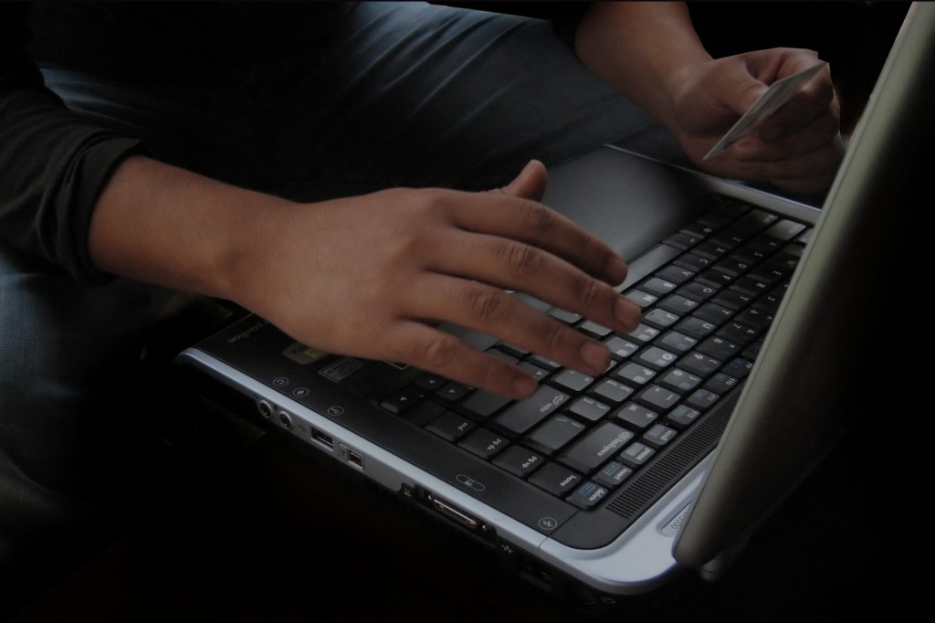 A person entering personal information on a laptop