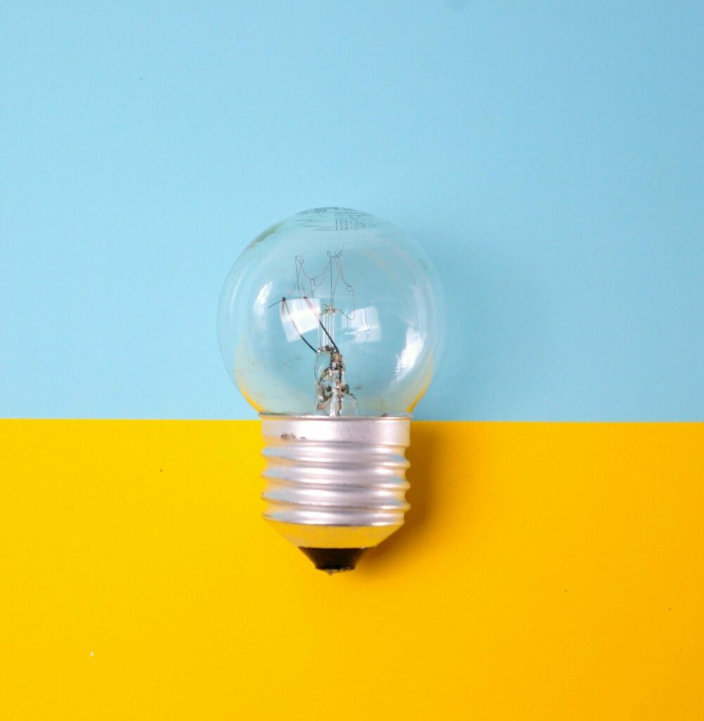 Background of blue and yellow with a lightbulb on one side.