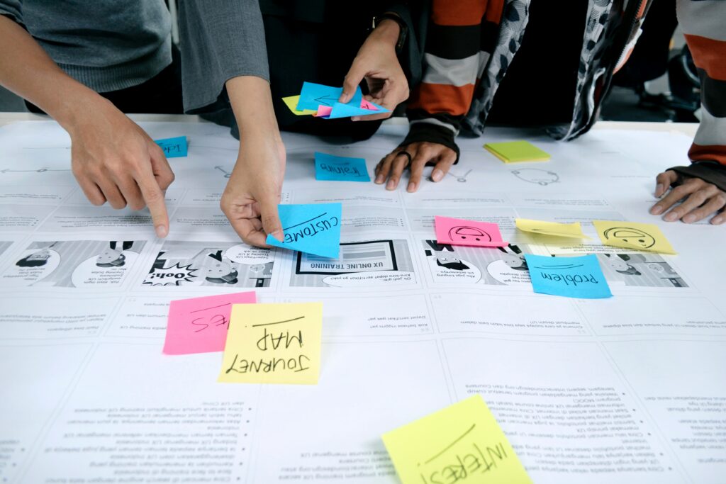 Why is UX important? A group of team members use post-its to understand their website's UX.